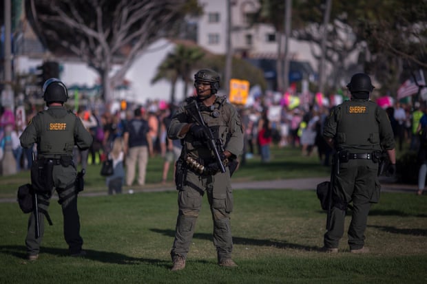 Sheriff’s deputies form a line to keep demonstrators and counter demonstrators apart during an ‘America first’ demonstration in California. Sheriffs across the US have said they won’t enforce state mask orders.