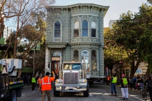 The 139-year-old Victorian house, known as the Englander House, is hoisted on a flat bed truck and pulled down Golden Gate Avenue towards its new location as the original site is to be used to build an eight-story apartment building in San Francisco.