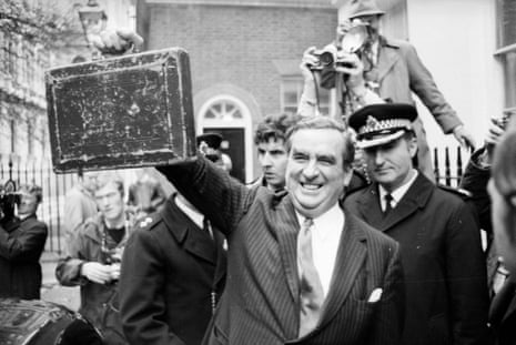 Denis Healey, British Chancellor of the Exchequer holds up his budget box in black and white photo