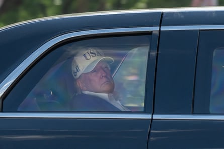 The US president, Donald Trump, in the back of a car in the US.