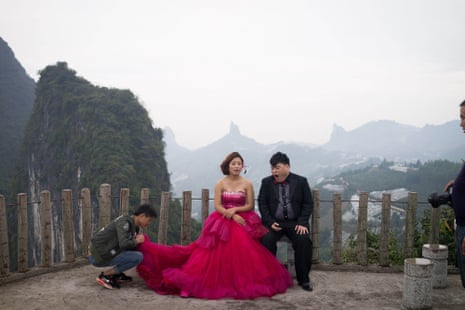 A couple photographed in front of the famous misty mountains in Guilin.