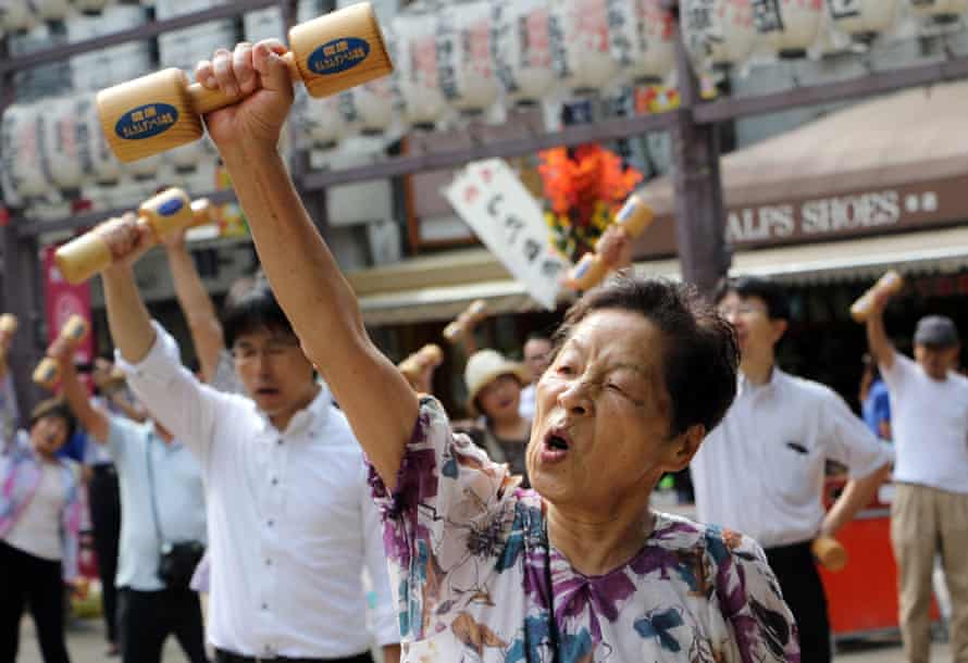 Elderly people work out with wooden dumb-bells in the grounds of a temple in Tokyo on September 21, 2015, to celebrate Japan’s Respect for the Aged Day. The estimated number of people aged 80 or older in Japan topped 10 million for the first time, the government announced.