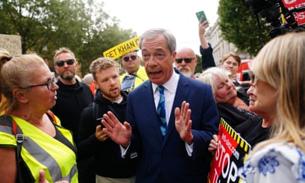 Nigel Farage speaking with protesters outside Downing Street on the first day of the expansion of the ultra-low emission zone (Ulez) to include the whole of London.