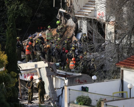 Emergency personnel work on Monday at the site of a missile strike in Haifa, Israel