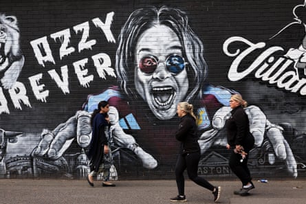 Mural of the late Ozzy Osbourne in black and white paint, showing him with hands reaching forward and characteristically mad grin