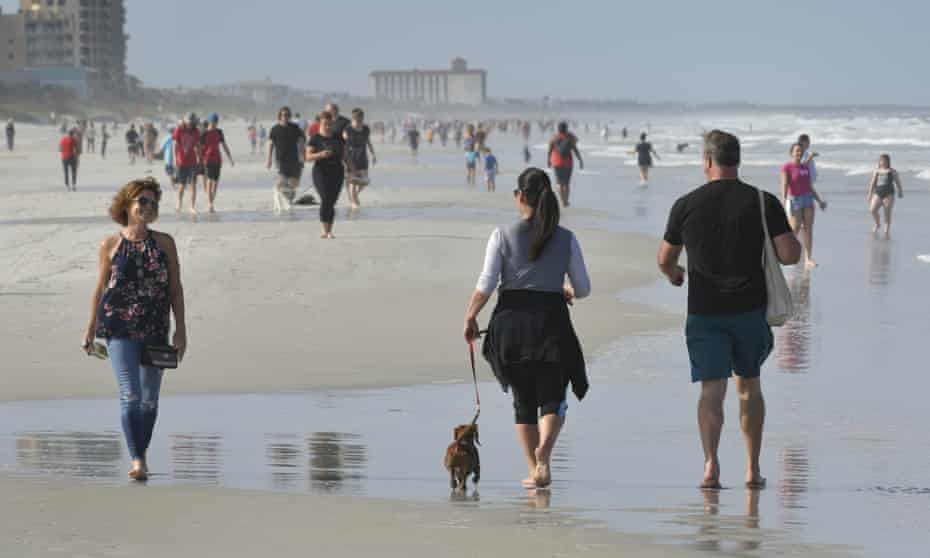 People walk on the beach during the coronavirus pandemic on Friday.
