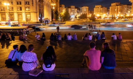 A musician performs in front of a small gathering in Kyiv