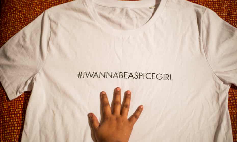 A hand on a charity Spice Girls T-shirt