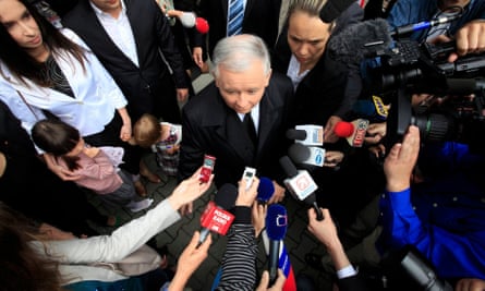 Jarosław Kaczyński, presidential candidate of Poland’s Law and Justice Party is surrounded by media as he leaves a polling station in Warsaw.