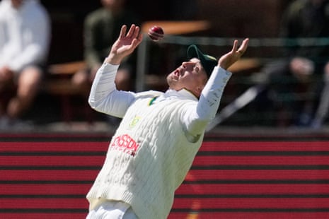 Matthew Breetzke leaps with arms raised, attempting a catch during a cricket test match