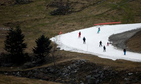 Skiers pass on an artificial ski snow slope on a mild winter day in the Barèges ski resort, Hautes-Pyrenees, south-western France, this month.