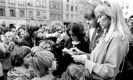 Fältskog signing autographs, stood next to her then-husband Björn Ulvaeus and Anni-Frid Lyngstad of Abba, in Warsaw, 1976.