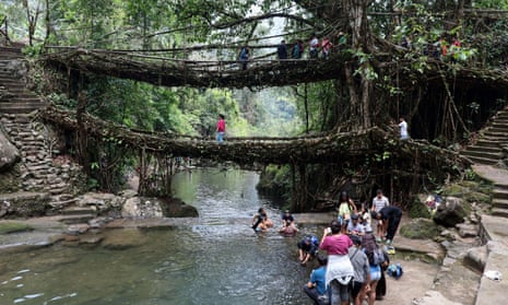 Tourists visit the double-decker living root bridge in Nongriat village, Meghalaya.