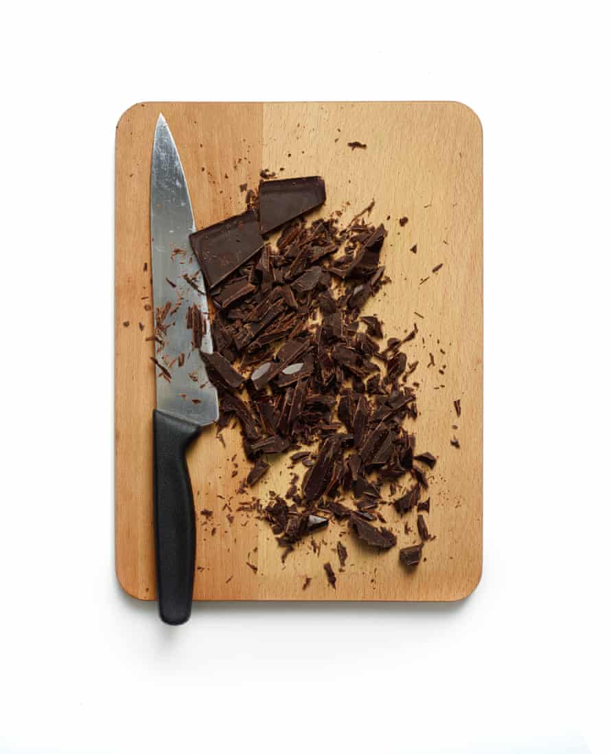 Chopping board with large knife and chocolate shards