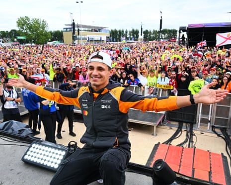 Lando Norris celebrates his first British GP victory with fans at Silverstone.