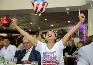 Julia del Rio cheers as she watches a televised broadcast of the presidential inauguration of Donald Trump, at a party by Hispanics for Trump in Miami, Florida