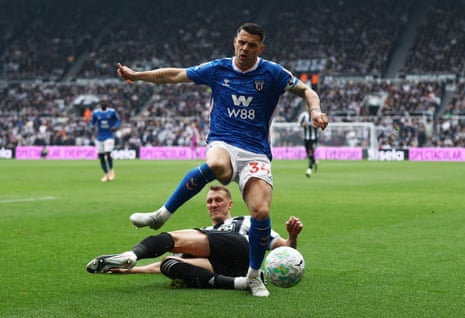 Granit Xhaka runs the ball out of play as Big Dan Burn slides in.