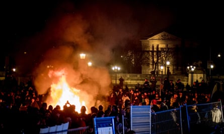 Protesters gather around a fire lit in Place de la Concorde.