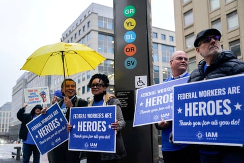people hold signs that read 'federal workers are heroes thank you for all you do'