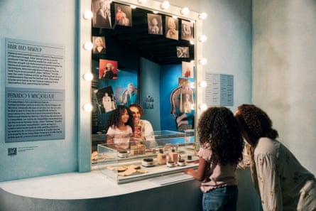 a young girl and woman looking in a mirror