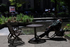 A man sleeps in Collect Pond Park across from Manhattan Criminal Court.