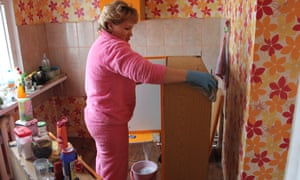 Nadezhda Scherbakova moves furniture out of her flat after thawing permafrost caused the structure to crack.