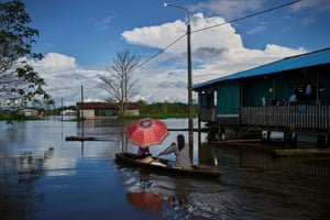 A woman sells slices of cake with her daughter from a canoe in Belén, a district nicknamed ‘Venice of the Jungle’ in Iquitos