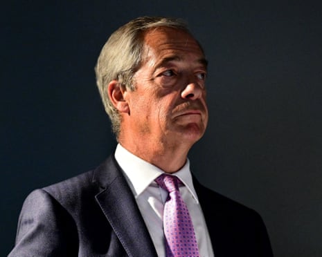 Nigel Farage looks to the side during a press conference