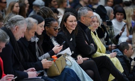 Caroline Rush smiles while sat on the front row