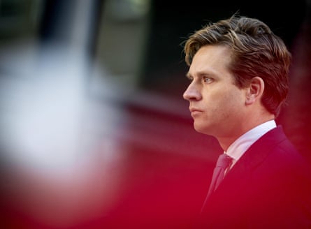 A distorted object in the foreground with a man in the background looking into the distance