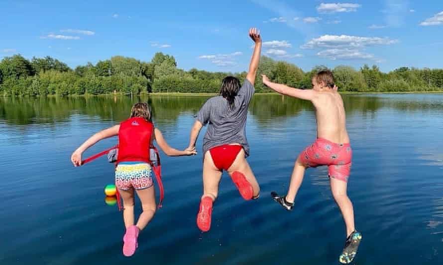 Three people jumping in the water