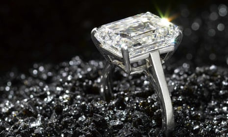 An emerald-cut diamond single-stone ring by De Beers