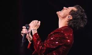Harry Styles kicks off the evening’s celebrations with a live performance in a shimmering ruby red jacket.