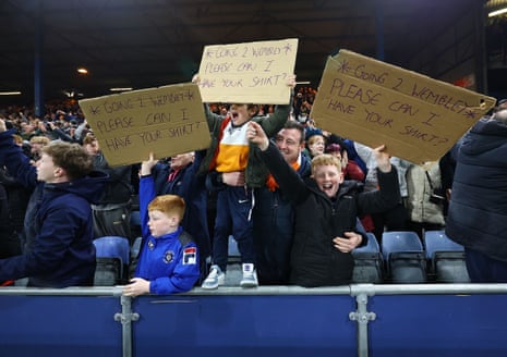Fans of Luton Town celebrate after the final whistle in their team’s Vertu Trophy semi-final victory over Northampton Town.