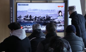 People watch a TV report on the crisis in Ukraine at the railway station in Seoul, South Korea