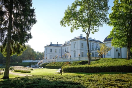 A large white mansion with formal gardens