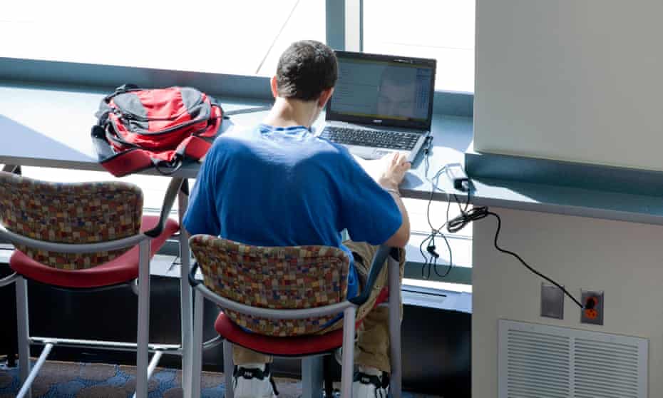 A file photo of a university student working on his laptop computer