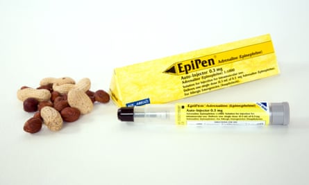 An EpiPen containing adrenaline and a selection of nuts