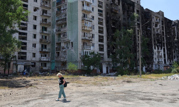 A local resident near a damaged apartment block in Sievierodonetsk