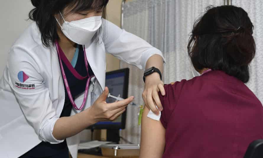 A medical worker receives a dose of the Pfizer/BioNTech vaccine in South Korea