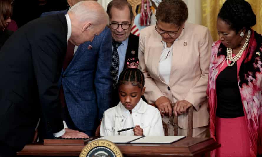 Gianna Floyd, the daughter of George, holding a pen used by Joe Biden to sign an executive order enacting further police reform, in the East Room of the White House yesterday.