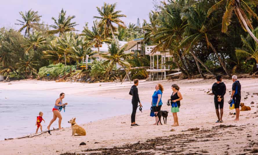 Tourists enjoy the pristine beaches of Rarotonga, Cook Islands.
