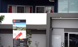 A ‘for sale’ sign is seen outside a new apartment complex in Sydney