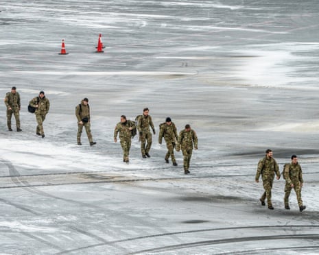 Danish soldiers walk across the frozen tarmac after arriving at Nuuk airport, Greenland.