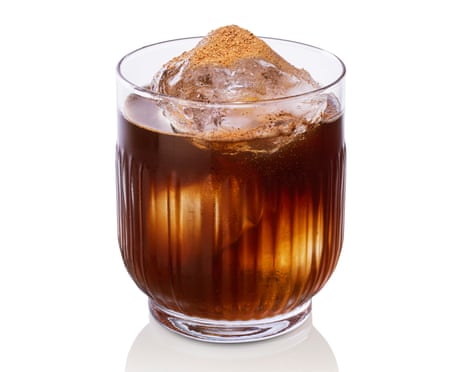 A glass of Buster's stout punch with crushed ice and a dusting of brown spice on top