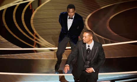 Chris Rock reacts after being slapped by Will Smith at the Oscars.