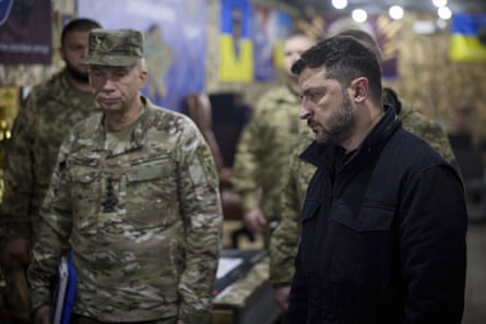 President Zelenskyy stands with military personnel