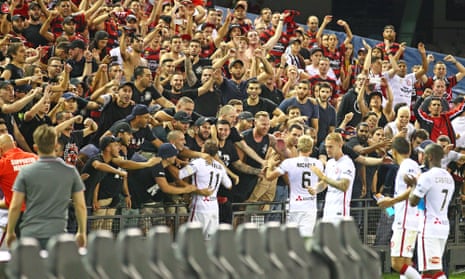 Western Sydney Wanderers players and fans. In Australia the sound and movement in the stands is what differentiates football as a sporting experience 