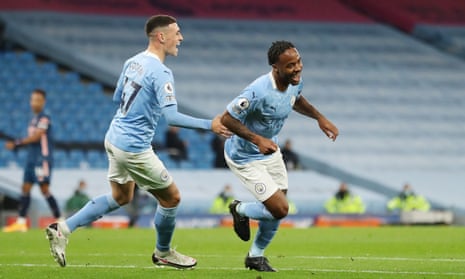 Raheem Sterling wheels away from Phil Foden after scoring on 23 minutes for Manchester City.