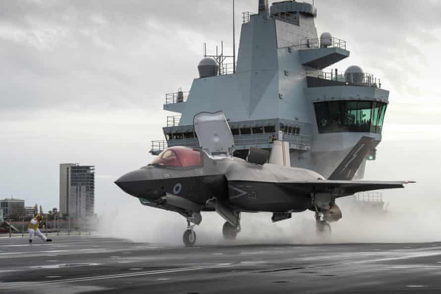 An RAF F-35B lightning jet preparing to take off from the flight deck of the HMS Queen Elizabeth at Portsmouth naval base.
